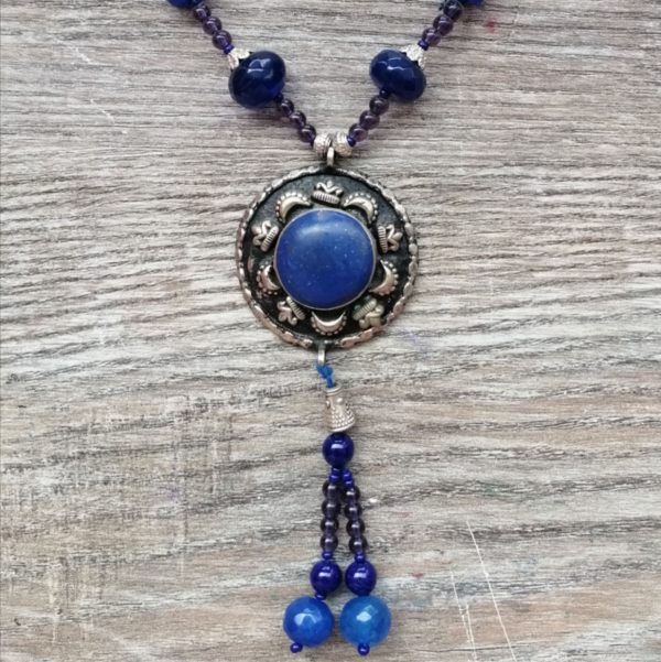 Sassy Blue - Handmade Kalasha Necklace The Sassy Blue necklace is a synonym of grace, elegance, and style. This vintage-inspired handmade Kalasha necklace comes in two shapes. A deep royal blue Lajvar stone shines as the centerpiece. Elevate your look with this perfect lavish essential. Colour: Blue Stone: Lajvar