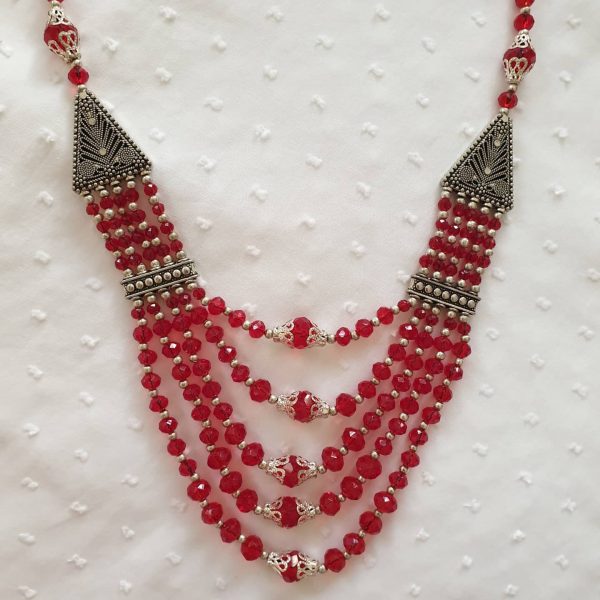 Ravishing Red - Handmade Kalasha Necklace The Ravishing Red necklace celebrates both style and elegance with traditional touch. Glistening red Aqeeq stones are arranged in five layers giving it an alluring look! This piece is perfect for formal and party wear, bound to make you feel like the queen of the event Colour: Red Stone: Aqeeq