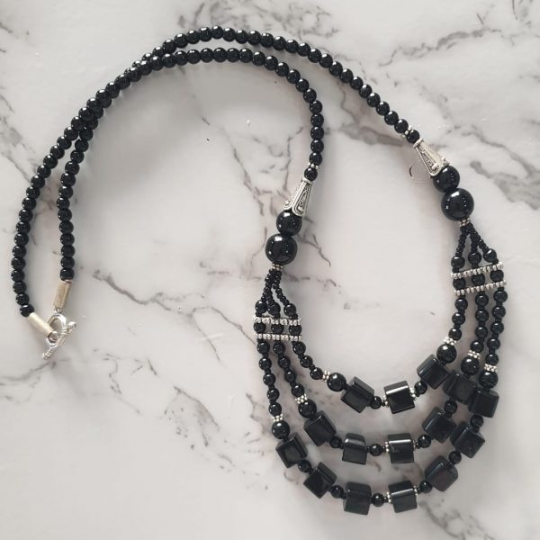 Charismatic Cubes - Handmade Kalasha Necklace The Charismatic Cubes necklace is the perfect blend of modern and antique. This triple-layered handmade Kalasha necklace comes in two colours and is just what you need to look dashing on a night out! Colour options: Black and Blue