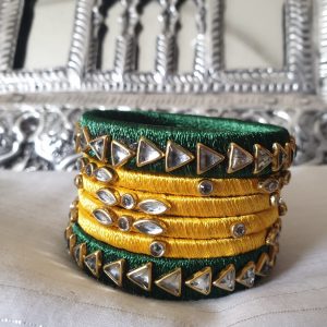Green & Yellow - Silk Thread Kundan Bangles Exquisite bangles wrapped in graceful diaphanous silk thread topped with dazzling Kundan embellishments. Handcrafted and designed to perfection, these bangles are lightweight, eye-catching, and the definition of elegance. Perfect for all occasions, be it an outing, a party, or a wedding, these bangles will always enhance and add to your look!