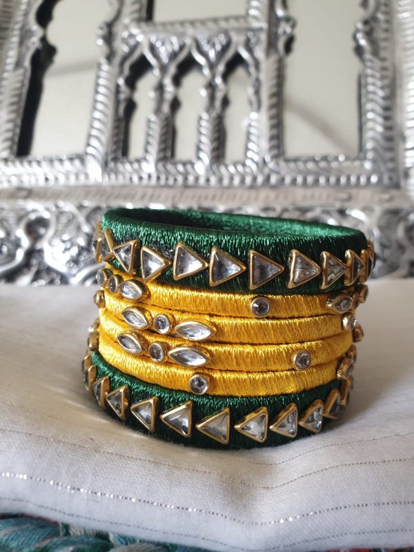 Green & Yellow - Silk Thread Kundan Bangles Exquisite bangles wrapped in graceful diaphanous silk thread topped with dazzling Kundan embellishments. Handcrafted and designed to perfection, these bangles are lightweight, eye-catching, and the definition of elegance. Perfect for all occasions, be it an outing, a party, or a wedding, these bangles will always enhance and add to your look!
