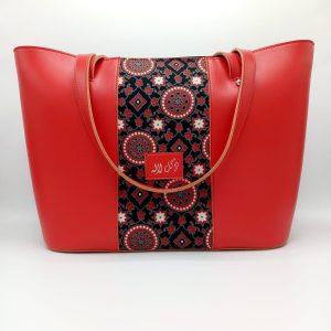 Vibrant Red - Faux Leather Tote Bag A classical handbag with a traditional twist. Featuring a simple & popular silhouette, this bag is perfect to carry everything you need to have with you when on the go! Made out of faux leather with traditional printed fabric incorporated to make it stand out and give it a desi touch!