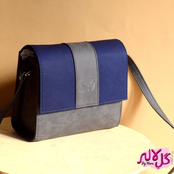 The Glam Bag - Grey Inspired by the energy and fervor of being on the go, we’ve created the everyday bag you’ve been dreaming of. The Glam Bag is a classic cross-body bag with a modern, smart-casual silhouette that is unexpectedly spacious. Featuring a strip of blue to give it a denim effect, adds the finishing touches! Locally made in Pakistan