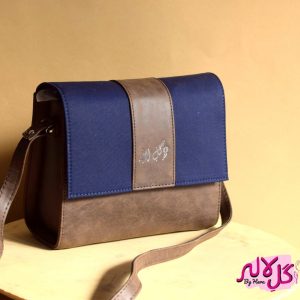The Glam Bag - Brown Inspired by the energy and fervor of being on the go, we’ve created the everyday bag you’ve been dreaming of. The Glam Bag is a classic cross-body bag with a modern, smart-casual silhouette that is unexpectedly spacious. Featuring a strip of blue to give it a denim effect, adds the finishing touches! Locally made in Pakistan