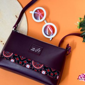 Marooned - Faux Leather Cross-Body Bag A classical cross-body bag with a traditional twist. Featuring a simple & popular silhouette, this bag is perfect to carry everything you need to have with you when on the go! Made out of faux leather with traditional printed fabric incorporated to make it stand out and give it a desi touch!