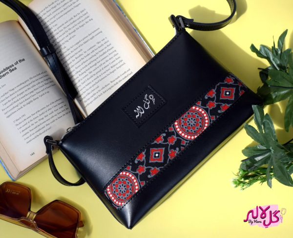 A classical cross body bag with a traditional twist. Featuring a simple & popular silhouette, this bag is perfect to carry everything you need to have with you when on the go! Made out of faux leather with traditional printed fabric incorporated to make it stand out and give it a desi touch! Colour: Size Length: Width: Depth: