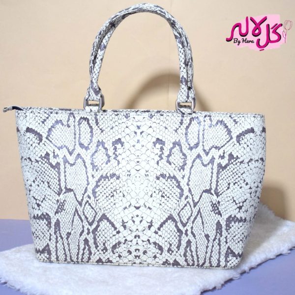 White Python - Faux Leather Hand Bag A shiny beautiful handbag with a chic snake print. Featuring a simple & popular silhouette, this bag is perfect to carry everything you need to have with you when on the go! Made out of faux leather with textured snake print tomake it stand out and give it a contemporary touch!