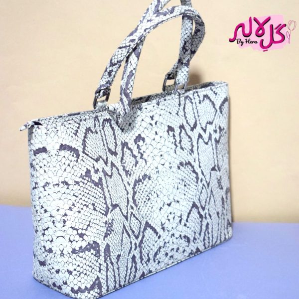 White Python - Faux Leather Hand Bag A shiny beautiful handbag with a chic snake print. Featuring a simple & popular silhouette, this bag is perfect to carry everything you need to have with you when on the go! Made out of faux leather with textured snake print tomake it stand out and give it a contemporary touch!