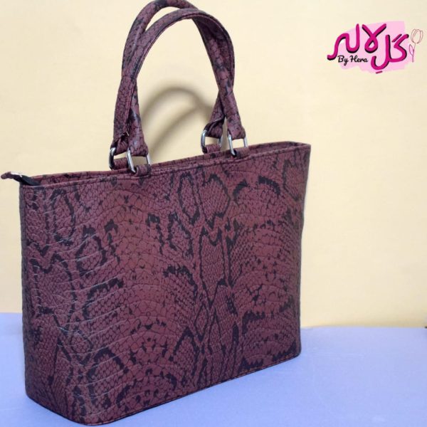 Brown Viper - Faux Leather Hand Bag A shiny beautiful handbag with a chic snake print. Featuring a simple & popular silhouette, this bag is perfect to carry everything you need to have with you when on the go! Made out of faux leather with textured snake print to make it stand out and give it a contemporary touch!