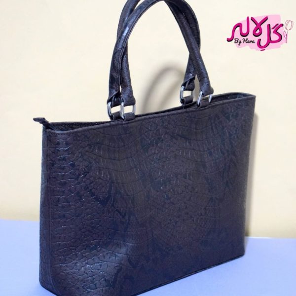 Black Cobra - Faux Leather Hand Bag A shiny beautiful handbag with a chic snake print. Featuring a simple & popular silhouette, this bag is perfect to carry everything you need to have with you when on the go! Made out of faux leather with textured snake print tomake it stand out and give it a desi touch!